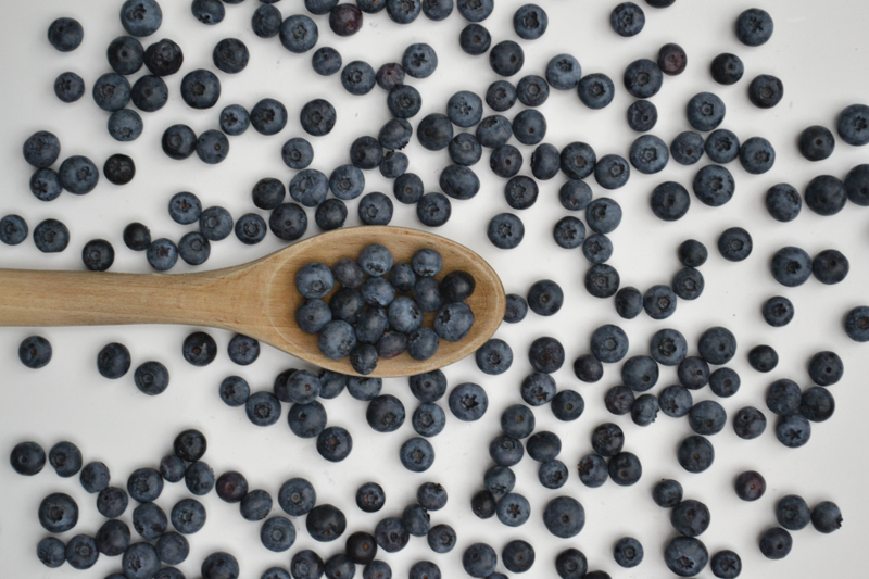 blueberries with a wooden spoon