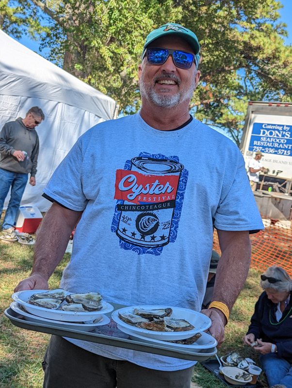 Festival patron with festival shirt and oysters